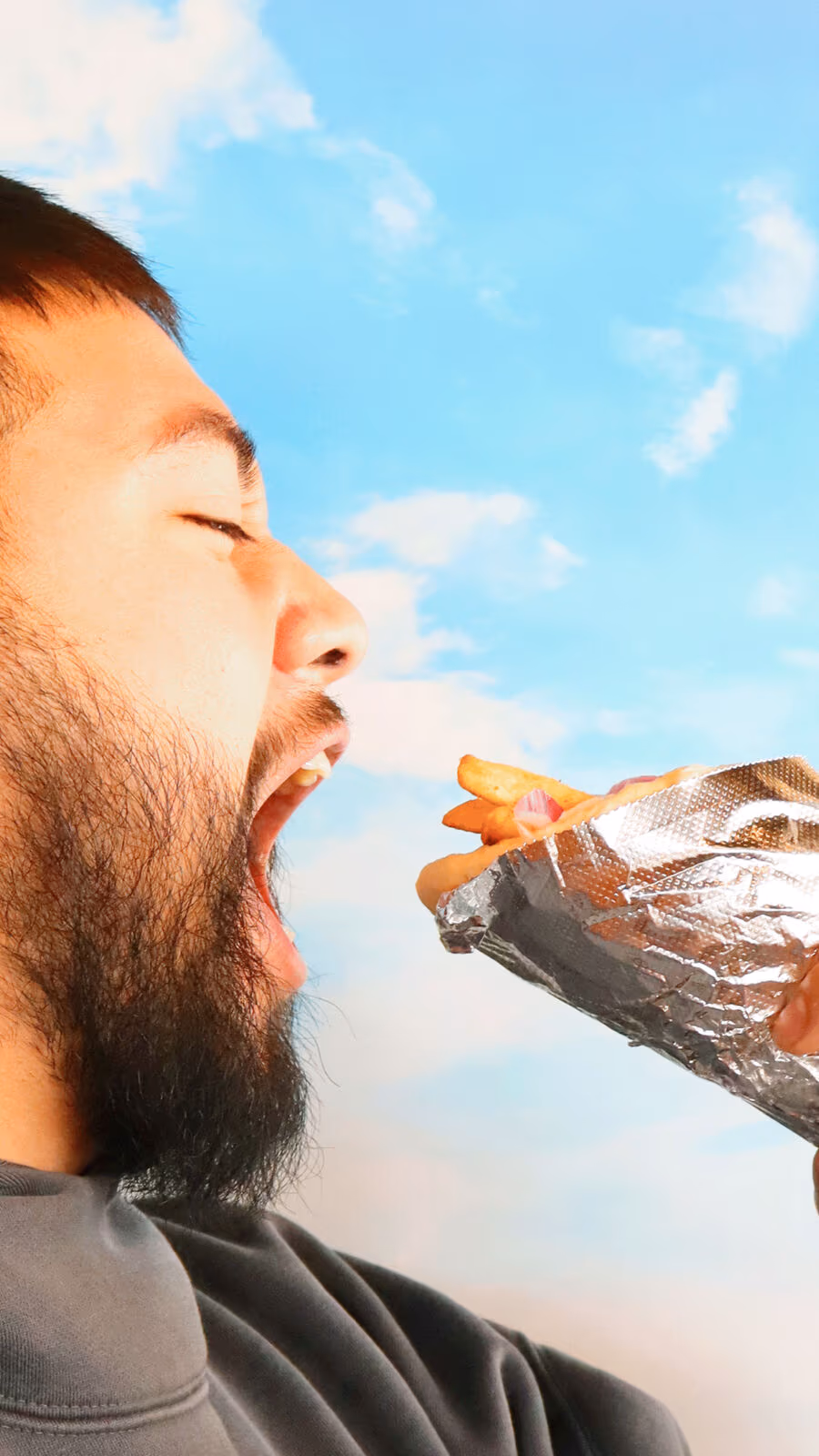 A customer digging into a Zestia gyro